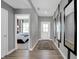 Hallway with wood-look flooring leading to a bedroom, and decorated with sleek mirrors at 1178 Turner Trace Pl, Avon, IN 46123