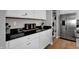 Stylish kitchen boasting white cabinets, black countertops, and stainless steel refrigerator at 1178 Turner Trace Pl, Avon, IN 46123