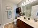 Neutral bathroom with a gray walls, dark wood cabinets, cream countertops, and modern fixtures at 1234 Yellowstone Way, Franklin, IN 46131