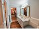 Beautiful bathroom featuring double sinks, quartz countertops, dark wood floors, and walk-in closet access at 1234 Yellowstone Way, Franklin, IN 46131