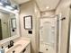 Well-lit bathroom with a framed mirror, vanity, and a walk-in shower featuring a glass door at 1234 Yellowstone Way, Franklin, IN 46131