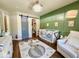 Green Bedroom featuring a crib, a plush chair, a modern door, and a whimsical rug for a serene environment at 1234 Yellowstone Way, Franklin, IN 46131