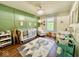 Charming Bedroom featuring a crib, rocking chair, a whimsical rug, and natural light for a peaceful environment at 1234 Yellowstone Way, Franklin, IN 46131