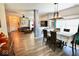 Open-concept dining area with hardwood floors, neutral decor, and access to living room at 1234 Yellowstone Way, Franklin, IN 46131
