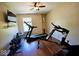 Bright exercise room featuring wood floors, a ceiling fan, and an assortment of exercise equipment at 1234 Yellowstone Way, Franklin, IN 46131