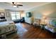 Spacious main bedroom with wood floors, sitting area, a large dresser, and bright natural light at 1234 Yellowstone Way, Franklin, IN 46131