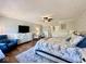 Primary bedroom suite with wood floors, neutral walls, and a large dresser and flatscreen TV at 1234 Yellowstone Way, Franklin, IN 46131