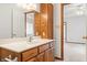 Bathroom features a wood vanity with plenty of storage space, a large mirror, and bright lighting at 126 Appian Way, Anderson, IN 46013
