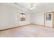 Spacious bedroom with neutral walls and carpet, a ceiling fan and a door to the backyard at 126 Appian Way, Anderson, IN 46013