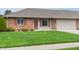 Charming brick home featuring a well-manicured lawn and attached one car garage at 126 Appian Way, Anderson, IN 46013