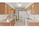 Well-lit kitchen featuring wooden cabinetry and modern white appliances at 126 Appian Way, Anderson, IN 46013