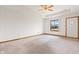 Bright living room with carpet, a ceiling fan, and a welcoming entrance at 126 Appian Way, Anderson, IN 46013
