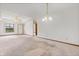 Open-concept living area featuring neutral carpet, fan, and access to dining at 126 Appian Way, Anderson, IN 46013