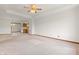 Spacious living room with neutral carpet, ceiling fan, and ample natural light at 126 Appian Way, Anderson, IN 46013