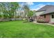 Expansive backyard featuring lush green grass and mature trees offering a private outdoor oasis at 13494 Dallas Ln, Carmel, IN 46033