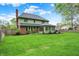 Extensive lawn that includes a brick home with a charming sunroom and patio at 13494 Dallas Ln, Carmel, IN 46033