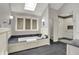 Bathroom featuring a tub, walk-in shower with a glass door, and skylight at 13494 Dallas Ln, Carmel, IN 46033