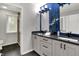 Bathroom with white cabinets, black hardware, stylish blue tiled wall at 13494 Dallas Ln, Carmel, IN 46033