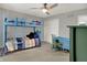 Cozy bedroom with a blue bunk bed, ceiling fan, and desk at 13494 Dallas Ln, Carmel, IN 46033