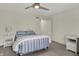 Comfortable bedroom with a metal bed frame, ceiling fan, and two nightstands at 13494 Dallas Ln, Carmel, IN 46033