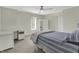 Well-lit bedroom with a ceiling fan, gray carpet, bed and white furniture at 13494 Dallas Ln, Carmel, IN 46033