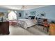 Comfortable blue bedroom with a ceiling fan, window seating, and traditional furniture at 13494 Dallas Ln, Carmel, IN 46033