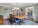 Elegant dining room with striped walls, hardwood table, chandelier, and access to other rooms at 13494 Dallas Ln, Carmel, IN 46033