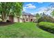 Two-story brick home with a three-car garage, lush lawn, and tasteful landscaping at 13494 Dallas Ln, Carmel, IN 46033