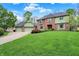 Charming brick home featuring a well-kept lawn, mature trees, and a three-car garage at 13494 Dallas Ln, Carmel, IN 46033