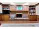 Wood burning brick fireplace with built-in cabinets and shelving, and wainscotting at 13494 Dallas Ln, Carmel, IN 46033