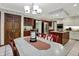 Kitchen open to the dining area with a kitchen island, wood cabinets, stainless steel appliances, and overhead lighting at 13494 Dallas Ln, Carmel, IN 46033