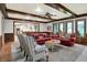 Large living room with a ceiling fan, wood trim, wainscotting, and a view into the kitchen at 13494 Dallas Ln, Carmel, IN 46033
