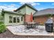 Brick house featuring a stone patio with an outdoor dining set and umbrella at 13494 Dallas Ln, Carmel, IN 46033