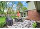 Enjoy a stone patio with a dining table, chairs, and grill for summer cookouts at 13494 Dallas Ln, Carmel, IN 46033