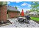 Stone patio with dining table and umbrella, great for outdoor entertainment at 13494 Dallas Ln, Carmel, IN 46033