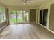 Enclosed sun room with tile flooring and multiple access points to the backyard at 13494 Dallas Ln, Carmel, IN 46033