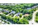 Aerial view of a lush, green neighborhood with single-Gathering homes and tree-lined streets on a sunny day at 13934 Salsbury Creek Dr, Carmel, IN 46032