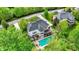 Stunning aerial view of home with a spacious backyard, pool, deck, and lush green trees, a perfect oasis for relaxation and entertainment at 13934 Salsbury Creek Dr, Carmel, IN 46032