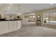 Finished basement area with a wet bar and an outdoor view of a pool and yard at 13934 Salsbury Creek Dr, Carmel, IN 46032