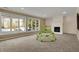 Bright basement with ample natural light, a fireplace and views of the backyard at 13934 Salsbury Creek Dr, Carmel, IN 46032