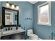 Modern bathroom featuring vanity with marble countertop, a black framed mirror, and a toilet adjacent to a window at 13934 Salsbury Creek Dr, Carmel, IN 46032