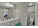 Bathroom featuring a double sink vanity, large mirror and access to toilet room at 13934 Salsbury Creek Dr, Carmel, IN 46032