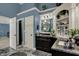 Bathroom featuring a granite vanity, modern sinks, and a unique corner cabinet feature at 13934 Salsbury Creek Dr, Carmel, IN 46032