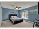 Serene bedroom with a bed, window seat, and blue accent wall at 13934 Salsbury Creek Dr, Carmel, IN 46032