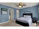 Comfortable bedroom with en-suite bathroom, a bed, and blue accent wall at 13934 Salsbury Creek Dr, Carmel, IN 46032