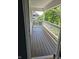 A view of the natural light filtering onto the brown wooden planks of an outdoor elevated deck at 13934 Salsbury Creek Dr, Carmel, IN 46032
