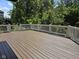 Spacious wooden deck perfect for outdoor entertaining, surrounded by lush green trees for privacy at 13934 Salsbury Creek Dr, Carmel, IN 46032