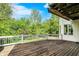 A spacious wooden deck overlooks lush greenery, providing an ideal spot for outdoor dining and relaxation at 13934 Salsbury Creek Dr, Carmel, IN 46032