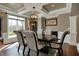 Elegant dining room featuring hardwood floors, coffered ceiling, and a spacious dining table at 13934 Salsbury Creek Dr, Carmel, IN 46032