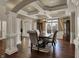 Elegant dining room with coffered ceiling, hardwood floors, and spacious dining table at 13934 Salsbury Creek Dr, Carmel, IN 46032